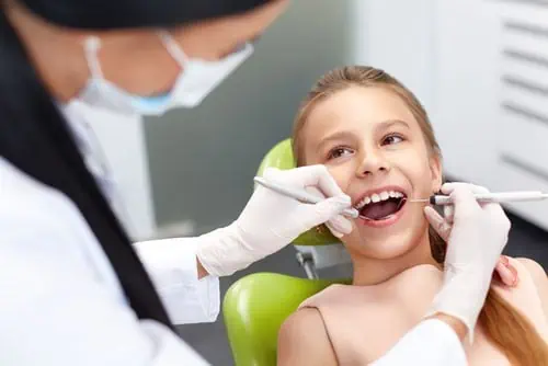 child getting checked for cavities