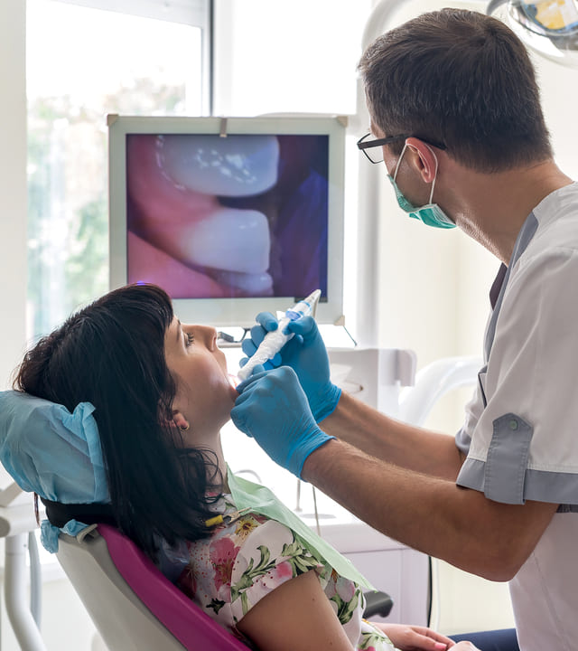 Dentist checking patient's teeth with diagnodent