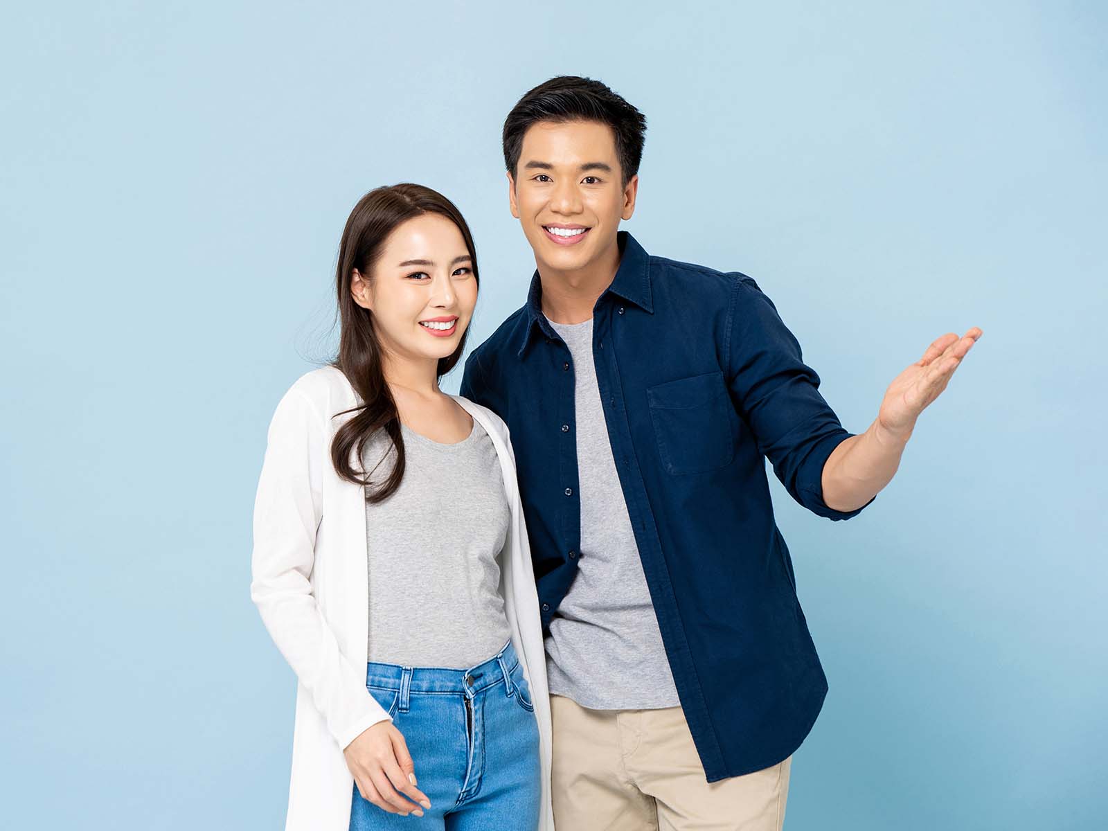 Young Asian couple standing next to each other smiling
